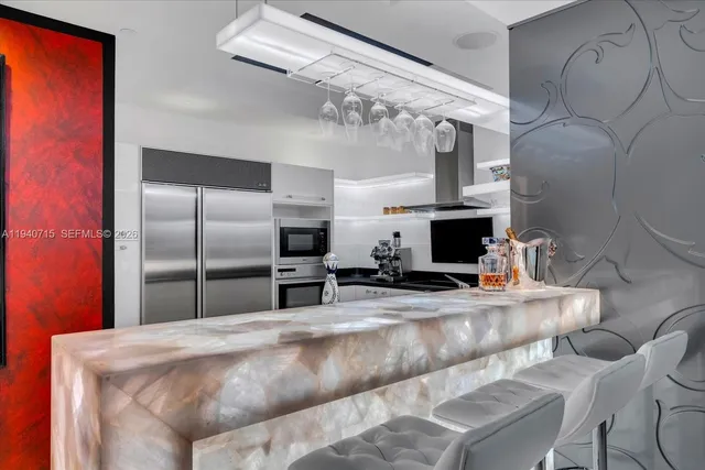 a dining room with furniture a chandelier and window
