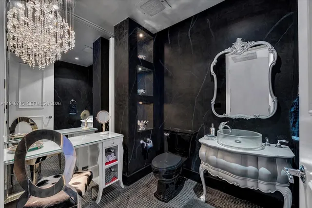 a view of a kitchen with kitchen island granite countertop a large window a sink stainless steel appliances and cabinets