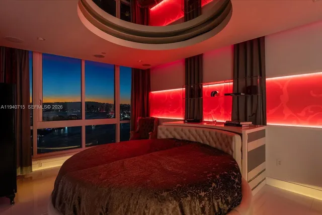 a room with furniture gym equipment and a large window