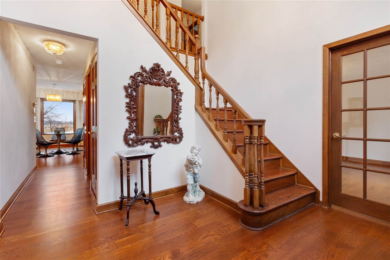 7022 Sentinel Road Rockford, IL 61107 - Photo 3 of 25 a view of staircase with a rug and a window