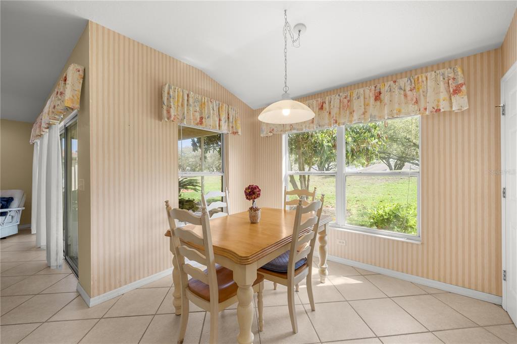 13421 Southeast 92nd Court Road Summerfield, FL 34491 - Photo 11 of 59 a dining room with furniture and window