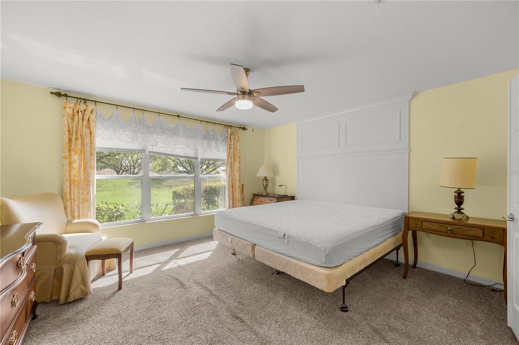 13421 Southeast 92nd Court Road Summerfield, FL 34491 - Photo 13 of 59 a bedroom with a bed and a large window