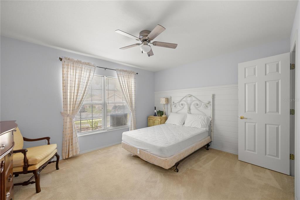 13421 Southeast 92nd Court Road Summerfield, FL 34491 - Photo 18 of 59 a spacious bedroom with a bed and a window