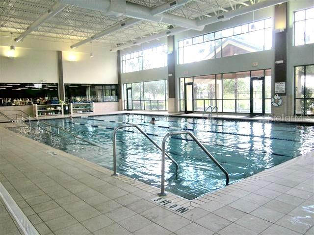 13421 Southeast 92nd Court Road Summerfield, FL 34491 - Photo 34 of 59 a swimming pool with outdoor seating