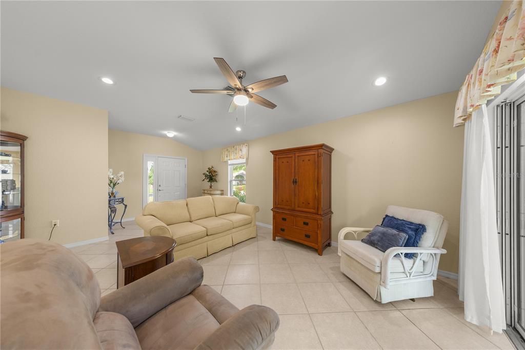 13421 Southeast 92nd Court Road Summerfield, FL 34491 - Photo 5 of 59 a living room with furniture and a ceiling fan