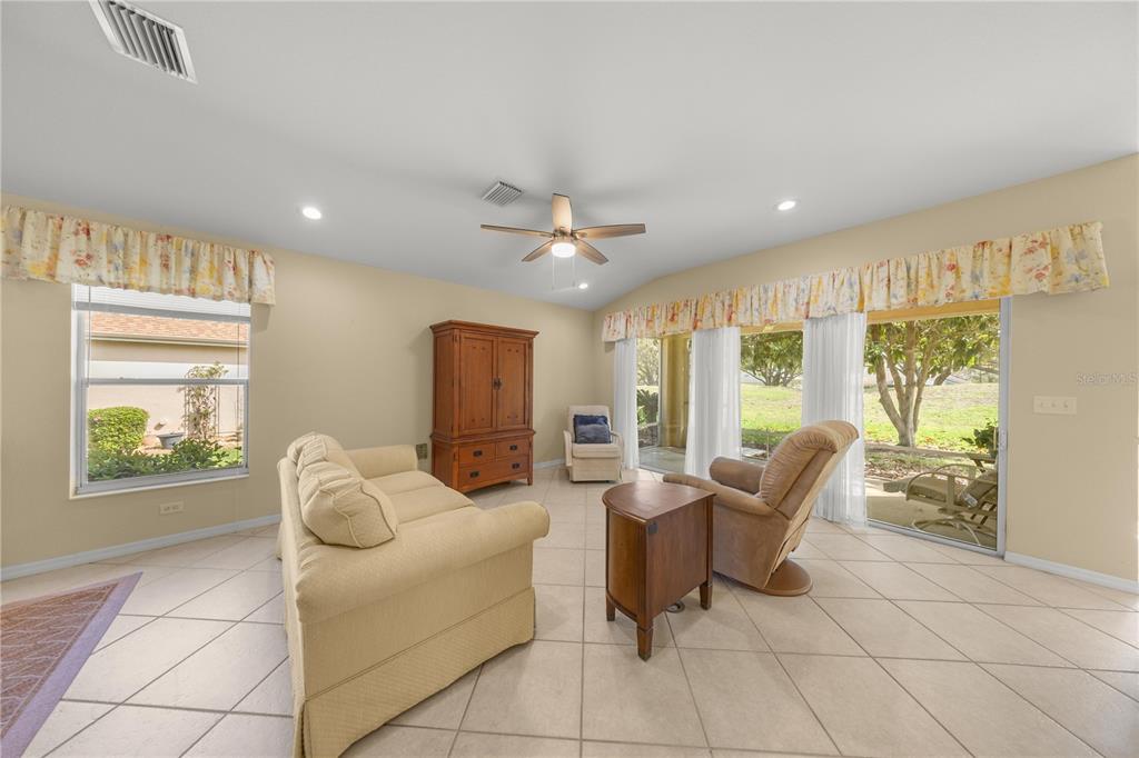 13421 Southeast 92nd Court Road Summerfield, FL 34491 - Photo 6 of 59 a living room with furniture and a large window