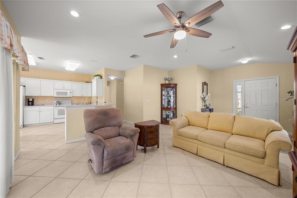13421 Southeast 92nd Court Road Summerfield, FL 34491 - Photo 7 of 59 a living room with furniture and kitchen view