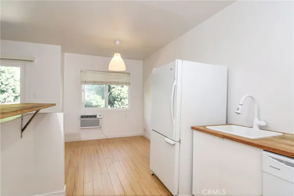 a kitchen with a refrigerator and a sink