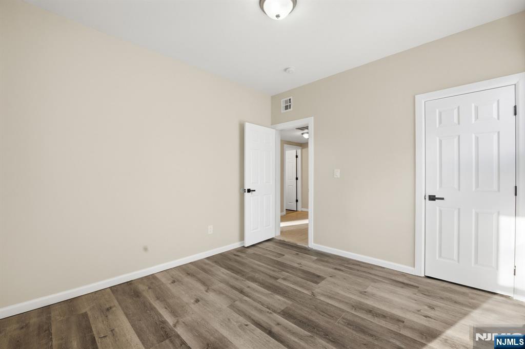 38 Mapes Avenue Newark, NJ 07112 - Photo 11 of 27 a view of an empty room with wooden floor