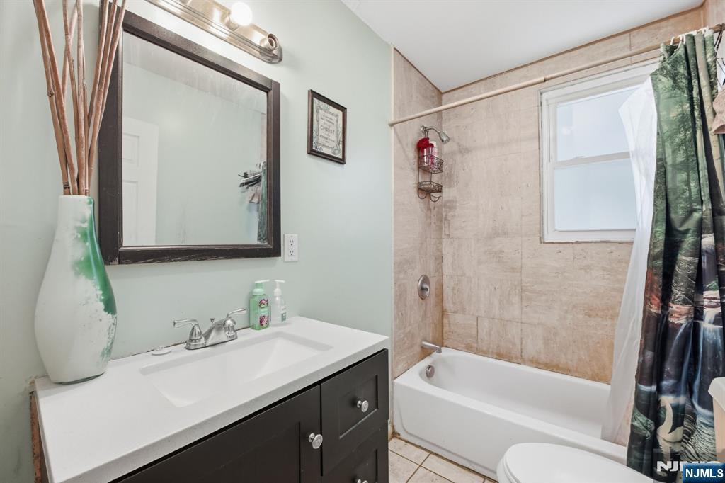 38 Mapes Avenue Newark, NJ 07112 - Photo 15 of 27 a bathroom with a granite countertop sink toilet and shower