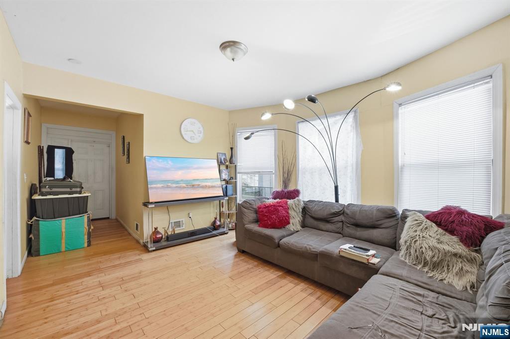 38 Mapes Avenue Newark, NJ 07112 - Photo 17 of 27 a living room with furniture and a large window