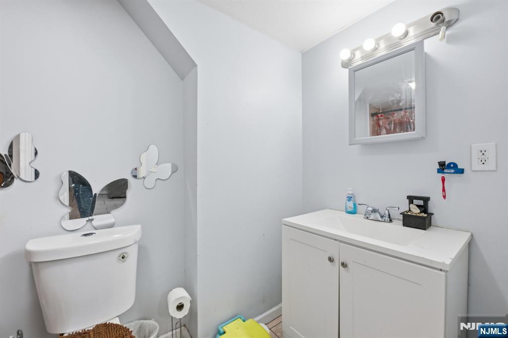 38 Mapes Avenue Newark, NJ 07112 - Photo 20 of 27 a bathroom with a sink mirror and toilet