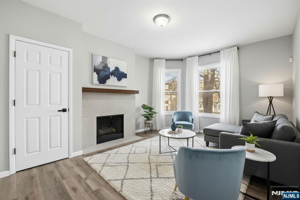 38 Mapes Avenue Newark, NJ 07112 - Photo 2 of 27 a living room with furniture and a fireplace