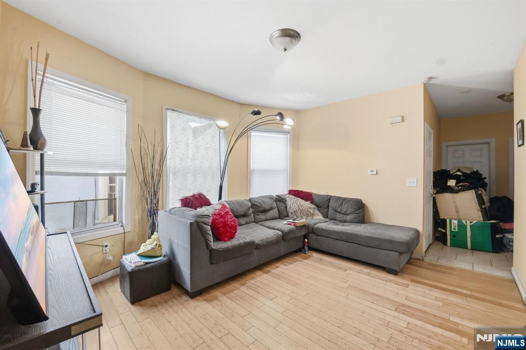 38 Mapes Avenue Newark, NJ 07112 - Photo 21 of 27 a living room with furniture and a large window