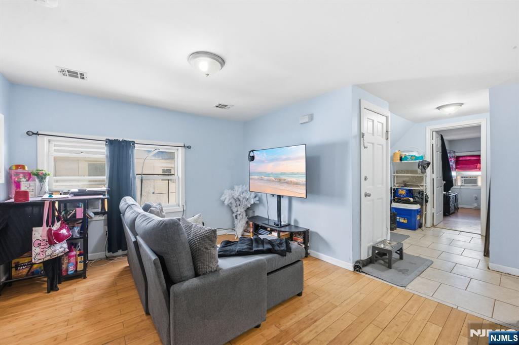 38 Mapes Avenue Newark, NJ 07112 - Photo 22 of 27 a living room with furniture and a flat screen tv