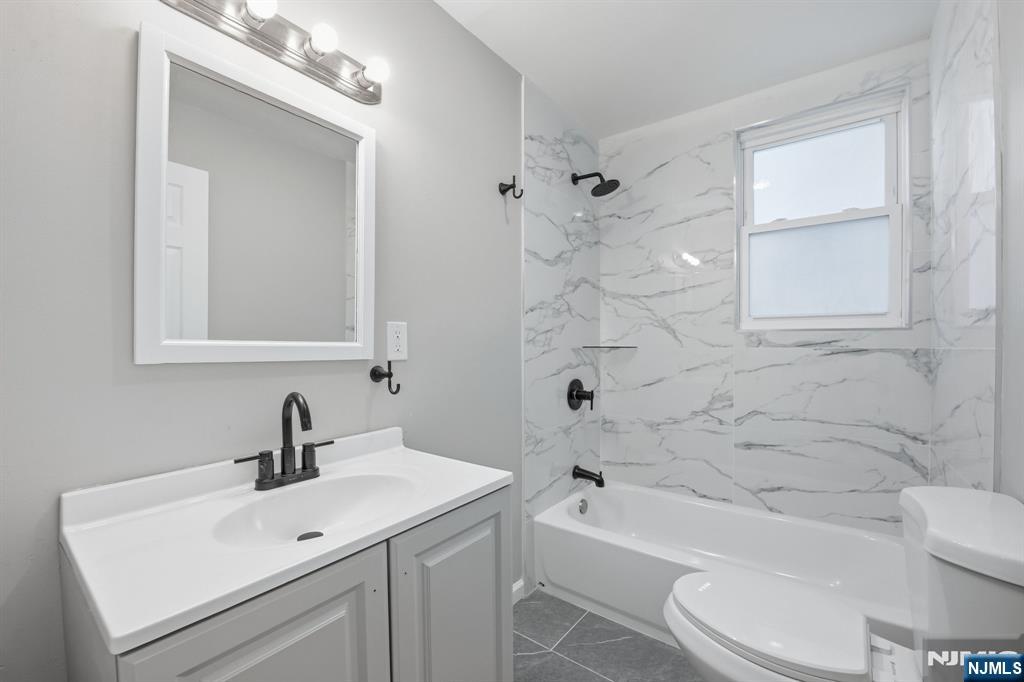 38 Mapes Avenue Newark, NJ 07112 - Photo 23 of 27 a bathroom with a sink a toilet and shower