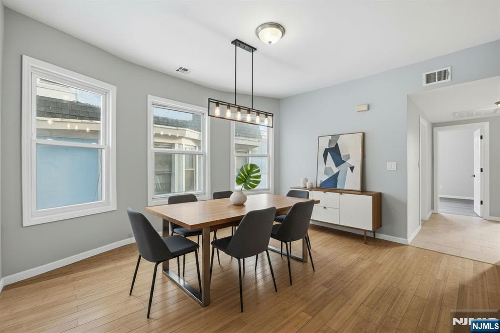38 Mapes Avenue Newark, NJ 07112 - Photo 4 of 27 a view of a dining room with furniture window and wooden floor