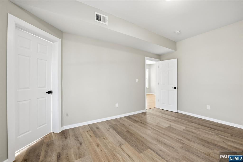 38 Mapes Avenue Newark, NJ 07112 - Photo 6 of 27 a view of an empty room with wooden floor