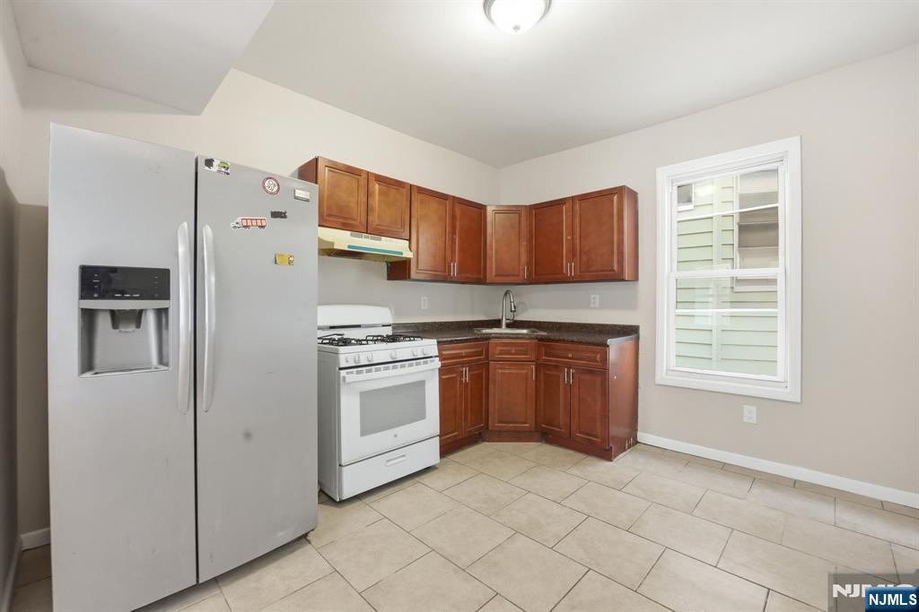 38 Mapes Avenue Newark, NJ 07112 - Photo 8 of 27 a kitchen with stainless steel appliances granite countertop a refrigerator sink and stove