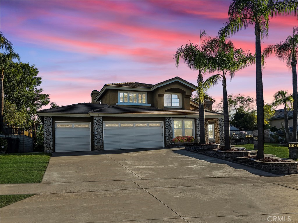 1881 Duncan Way Corona, CA 92881 - Photo 1 of 75 a front view of a house with a garden and a yard