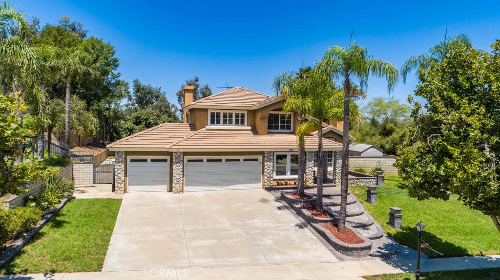 1881 Duncan Way Corona, CA 92881 - Photo 2 of 75 a front view of a house with garden