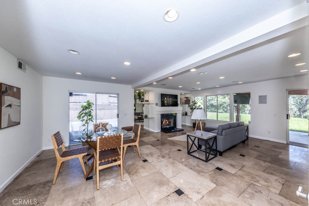 1881 Duncan Way Corona, CA 92881 - Photo 23 of 75 a living room with furniture a large window and a fireplace