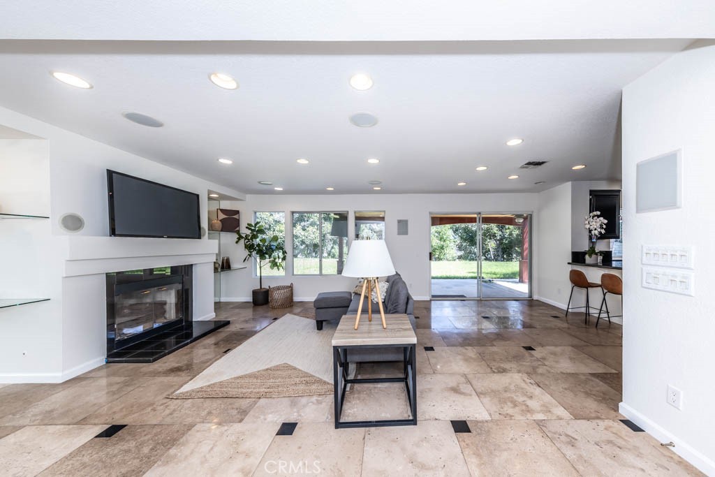 1881 Duncan Way Corona, CA 92881 - Photo 31 of 75 a living room with furniture a fireplace and a flat screen tv