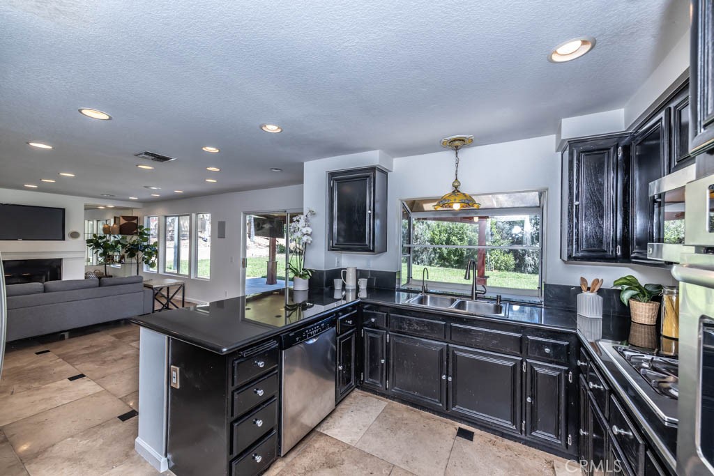 1881 Duncan Way Corona, CA 92881 - Photo 37 of 75 a kitchen with granite countertop a sink stove and cabinets