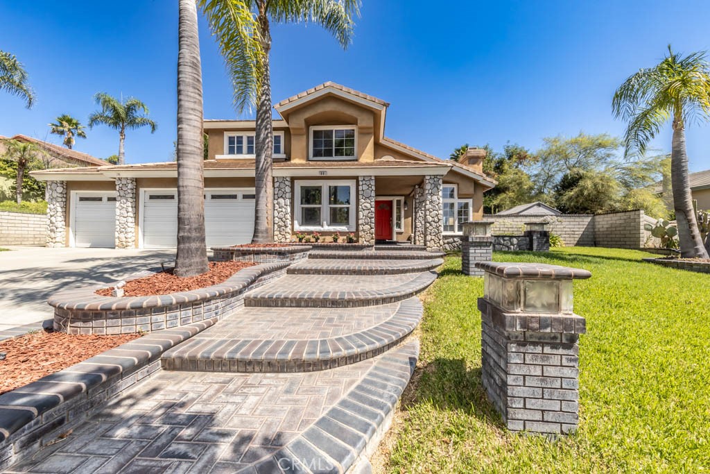 1881 Duncan Way Corona, CA 92881 - Photo 4 of 75 a front view of a house with a swimming pool