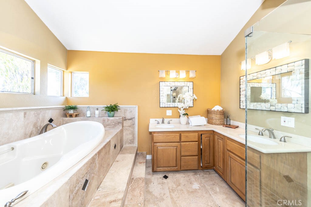 1881 Duncan Way Corona, CA 92881 - Photo 51 of 75 a spacious bathroom with a double vanity sink a mirror and a bathtub
