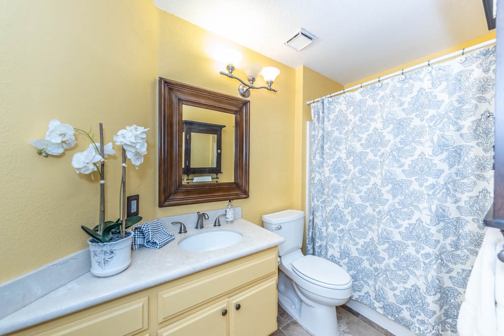 1881 Duncan Way Corona, CA 92881 - Photo 57 of 75 a bathroom with a granite countertop sink mirror and toilet