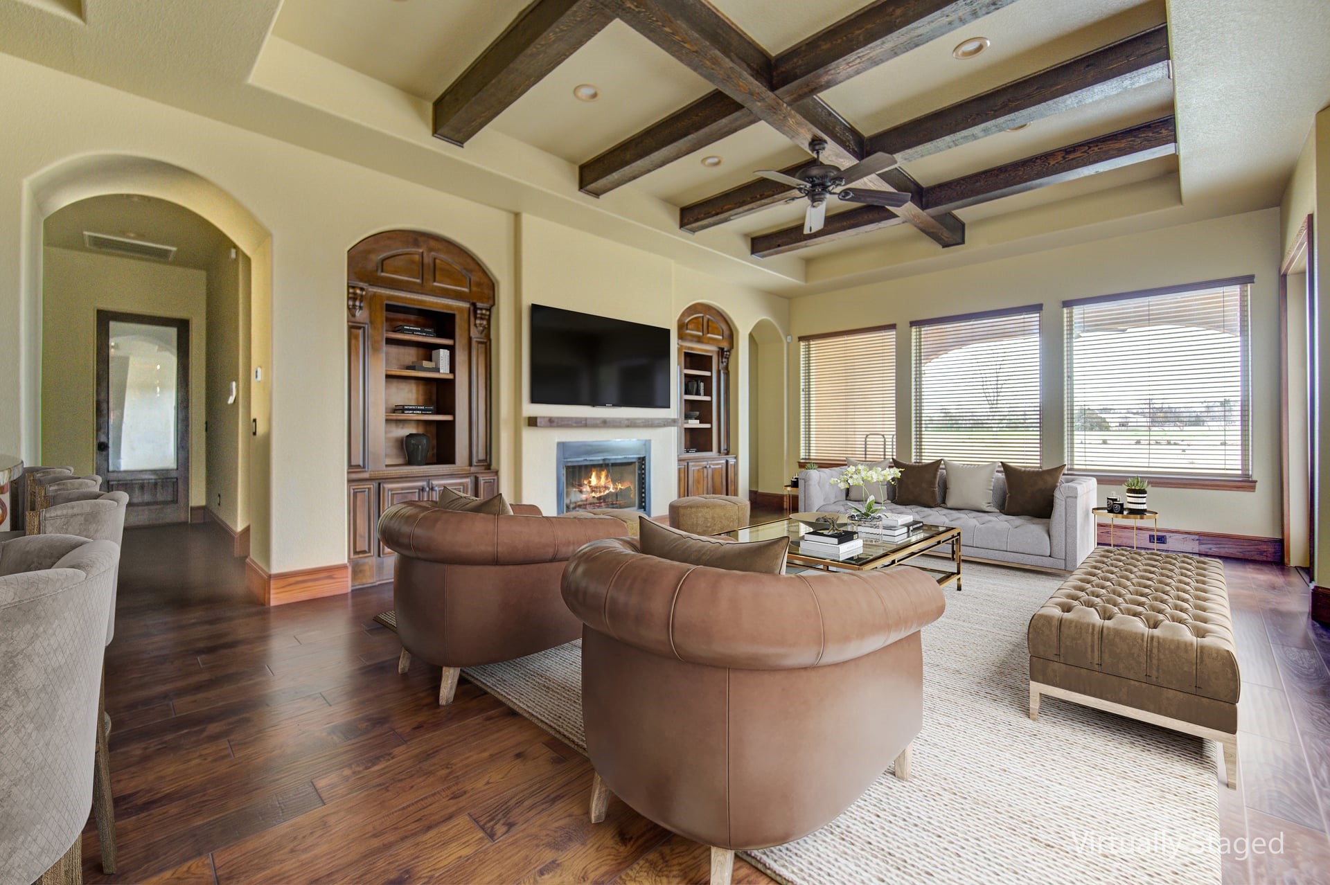 a living room with fireplace furniture and a large window