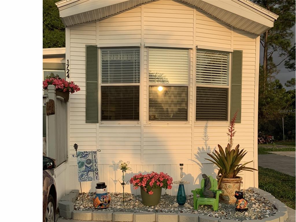 1724 East Manatee Loop Punta Gorda, FL 33950 - Photo 1 of 1 Front of home with bay window and decorative shutters