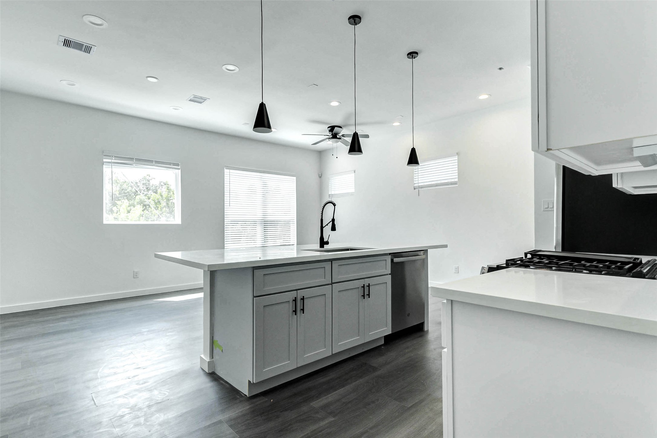 6017 Beall Street Houston, TX 77091 - Photo 12 of 33 The heart of the home! This oversized island anchors the kitchen and creates effortless flow into the living and dining areas. Matte black hardware and a flood of natural light add a stylish, welcoming touch.
