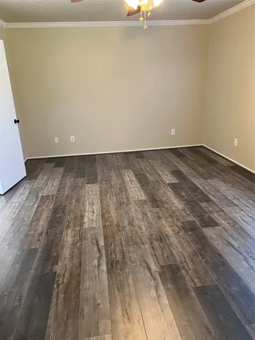 a view of a room with wooden floor