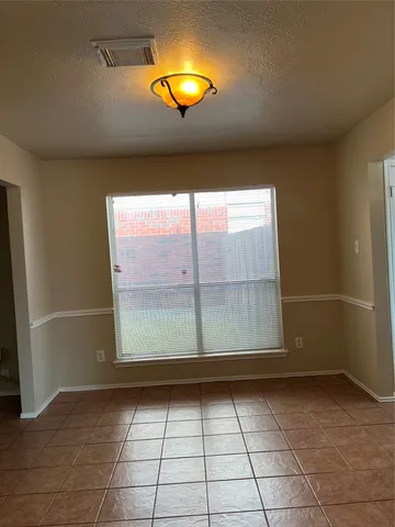 a view of empty room with a fireplace