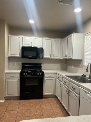 a kitchen with a sink and a stove top oven