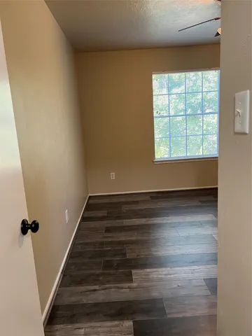 a view of wooden floor and windows in a room