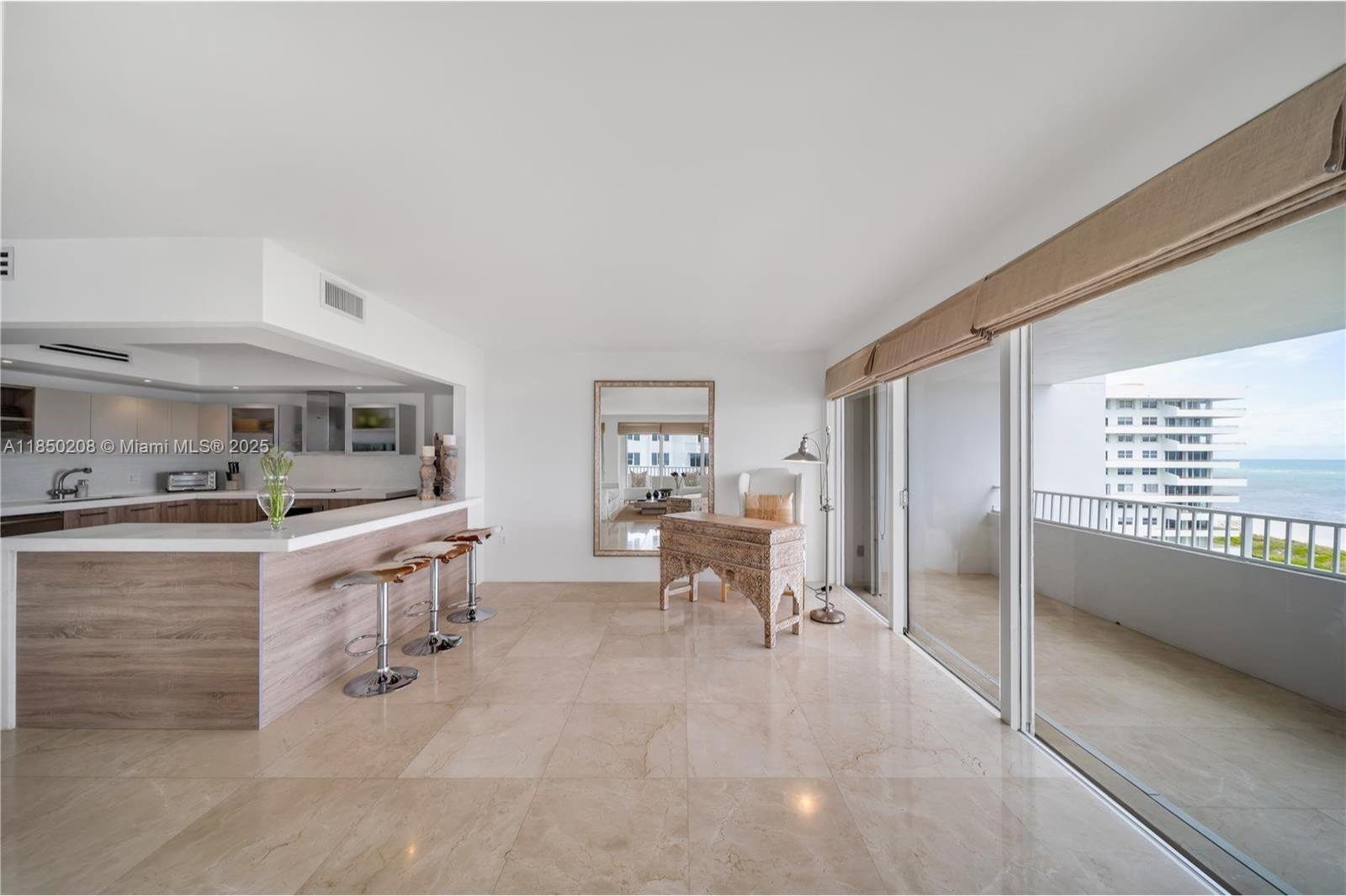 199 Ocean Ln Drive, Unit 901 Key Biscayne, FL 33149 - Photo 11 of 31 a kitchen with granite countertop a sink and chairs