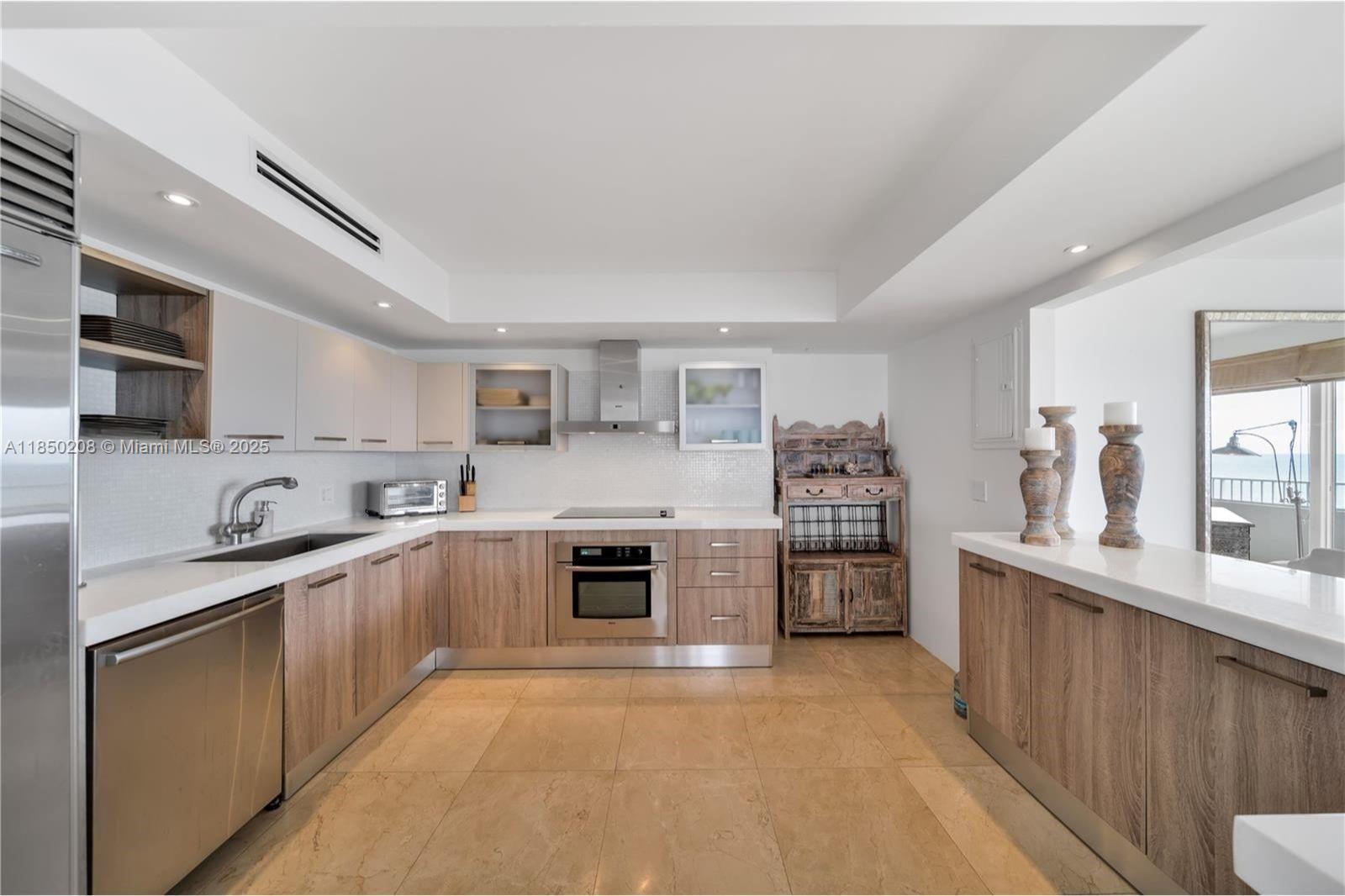 199 Ocean Ln Drive, Unit 901 Key Biscayne, FL 33149 - Photo 16 of 31 a kitchen with a sink a stove and cabinets