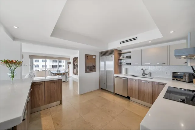 a kitchen with stainless steel appliances a refrigerator sink and cabinets