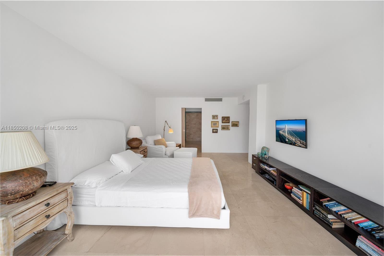 199 Ocean Ln Drive, Unit 901 Key Biscayne, FL 33149 - Photo 22 of 31 a bedroom with a bed and a flat screen tv