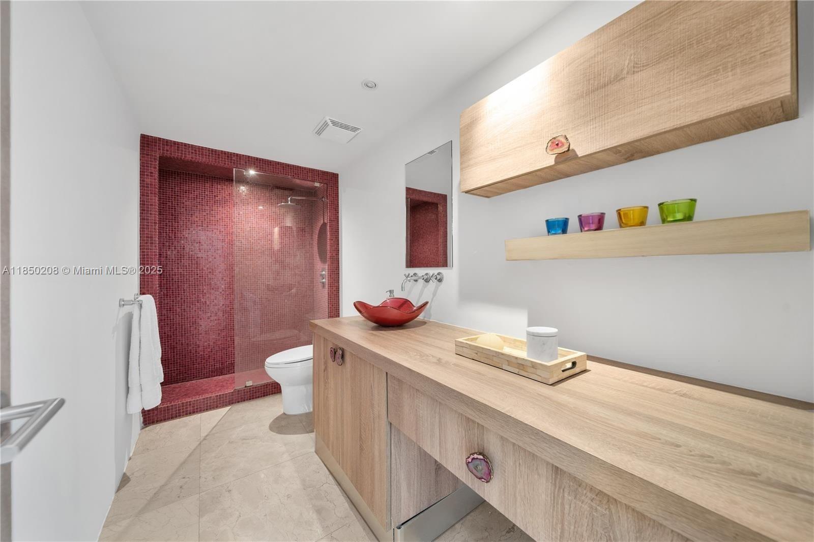 199 Ocean Ln Drive, Unit 901 Key Biscayne, FL 33149 - Photo 26 of 31 a bathroom with a sink a toilet and shower curtain