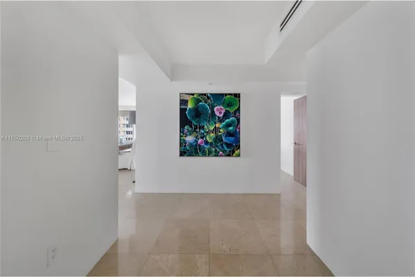 a view of a hallway with a painting on the wall