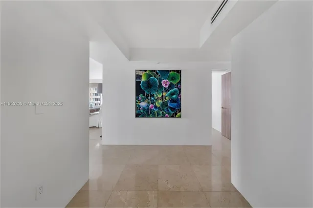 a view of a hallway with a painting on the wall