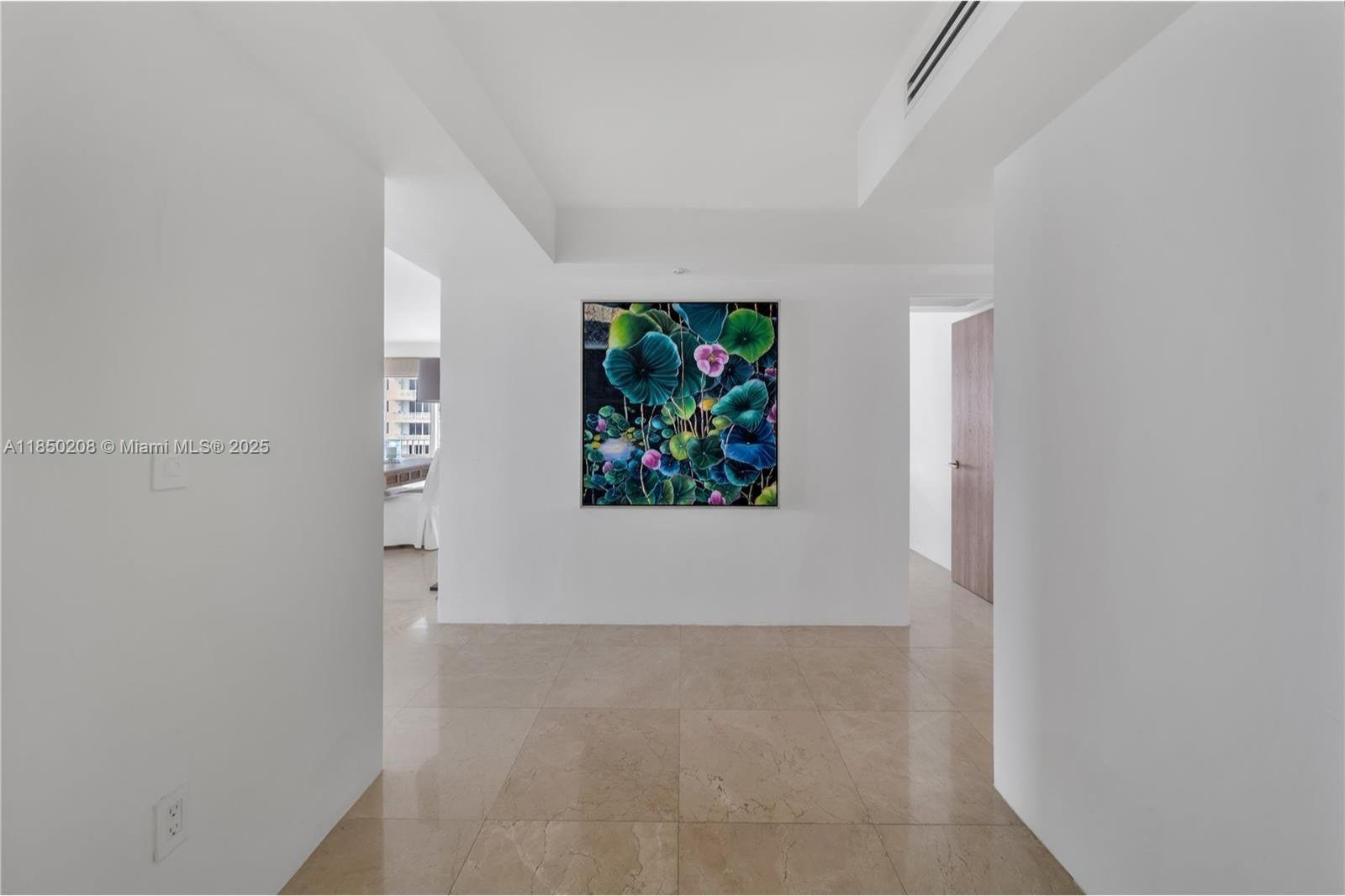 199 Ocean Ln Drive, Unit 901 Key Biscayne, FL 33149 - Photo 5 of 31 a view of a hallway with a painting on the wall