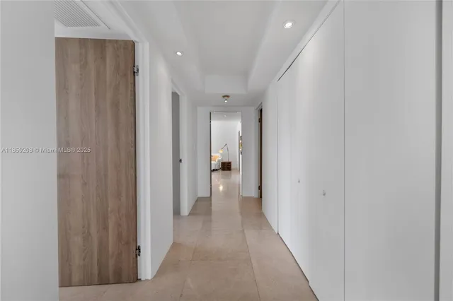 a dining room with furniture and a floor to ceiling window