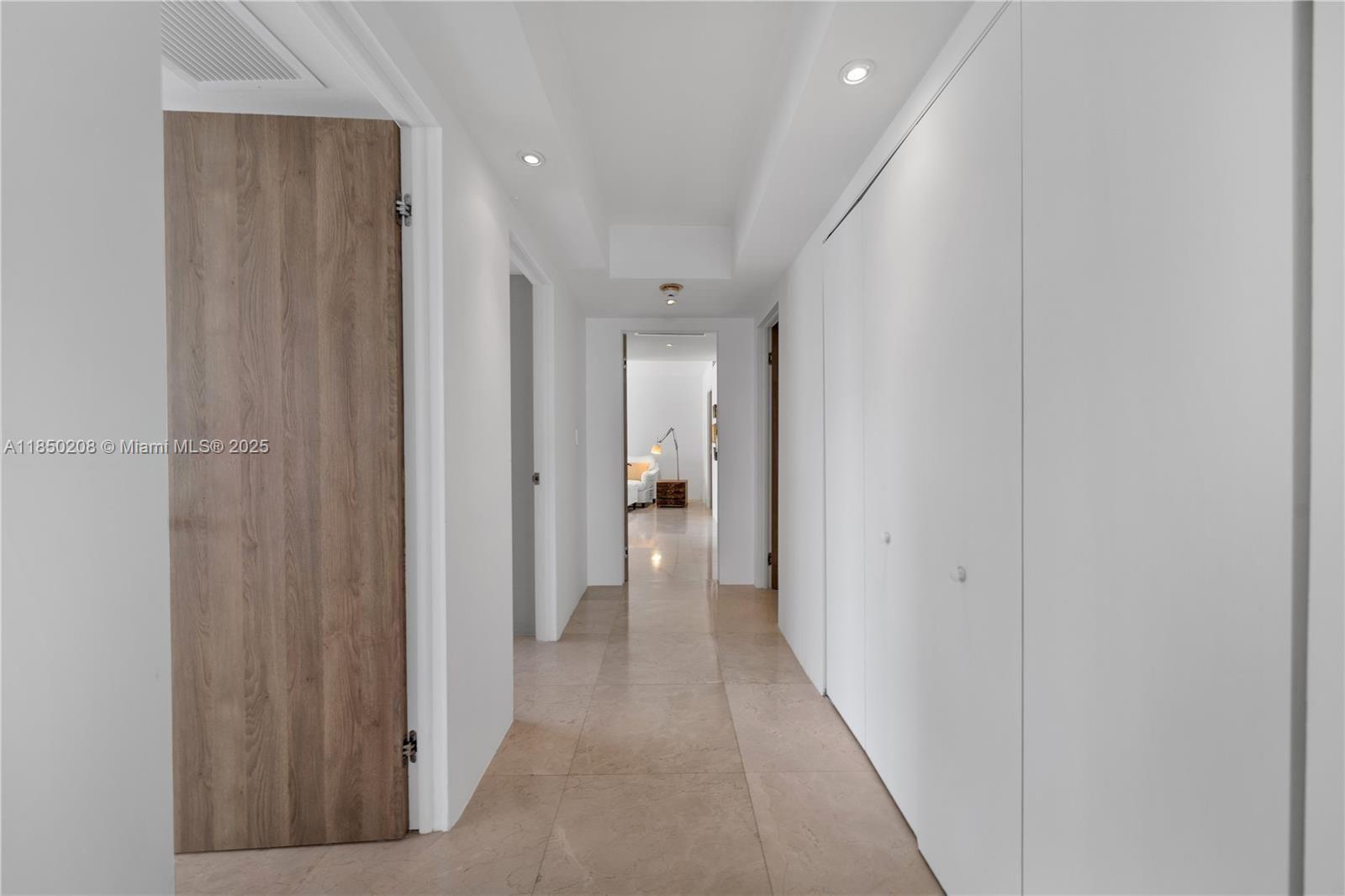 199 Ocean Ln Drive, Unit 901 Key Biscayne, FL 33149 - Photo 7 of 31 a view of a hallway with wooden shelves