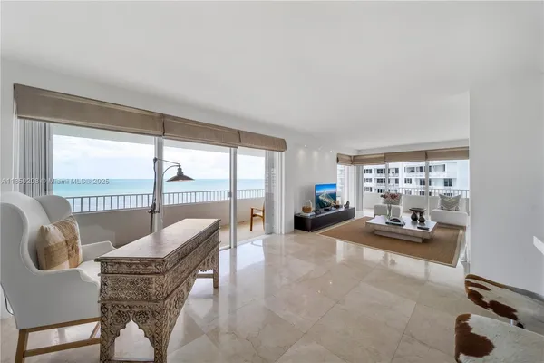 a kitchen with stainless steel appliances a stove a refrigerator a sink a microwave a dining table and chairs