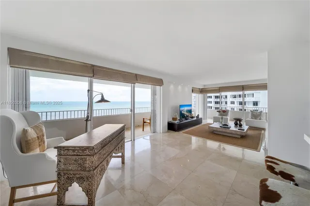 a kitchen with stainless steel appliances a stove a refrigerator a sink a microwave a dining table and chairs